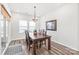 Bright dining room features wood floors, modern chandelier, and natural light from a sliding glass door at 5367 Turtle Creek Dr, Denver, NC 28037