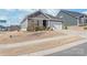 Charming one-story home with gray siding, stone accents, a two-car garage and professionally landscaped front yard at 5367 Turtle Creek Dr, Denver, NC 28037