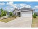 Charming single Gathering home with a two-car garage and manicured front yard at 5367 Turtle Creek Dr, Denver, NC 28037