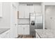 Stylish kitchen with white cabinets, stainless steel appliances, and a granite countertop at 5367 Turtle Creek Dr, Denver, NC 28037