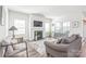 Airy living room featuring a fireplace, neutral-toned furnishings, and hardwood floors at 5367 Turtle Creek Dr, Denver, NC 28037