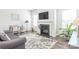 Cozy living room featuring a fireplace, hardwood floors, and neutral decor at 5367 Turtle Creek Dr, Denver, NC 28037
