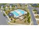 Aerial view of the community pool area with a unique shape, surrounded by lounge chairs, umbrellas, and landscaping at 5367 Turtle Creek Dr, Denver, NC 28037