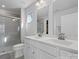 Bathroom featuring double sinks, white cabinets, and a glass-enclosed shower at 609 Grandiflora Ave, Lancaster, SC 29720