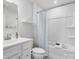 Clean bathroom featuring a shower-tub combo with a white shower curtain, white walls and vanity at 609 Grandiflora Ave, Lancaster, SC 29720