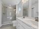 Bathroom featuring double sinks, white cabinets, and a glass-enclosed shower at 609 Grandiflora Ave, Lancaster, SC 29720