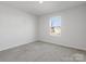Minimalist bedroom features neutral carpet, white walls and one window providing natural light at 609 Grandiflora Ave, Lancaster, SC 29720