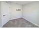 Neutral bedroom with gray carpet, white walls, and modern door at 609 Grandiflora Ave, Lancaster, SC 29720