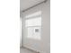 Bright bedroom features window with white blinds, white walls, and neutral carpet at 609 Grandiflora Ave, Lancaster, SC 29720