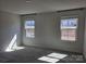 Empty bedroom featuring gray carpet, light gray walls, and two windows with views at 609 Grandiflora Ave, Lancaster, SC 29720