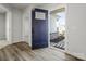Inviting entryway with stylish dark blue front door, wood-look flooring, and neutral wall colors at 609 Grandiflora Ave, Lancaster, SC 29720