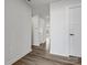 Hallway with hardwood style flooring and three white doors at 609 Grandiflora Ave, Lancaster, SC 29720