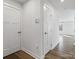 Hallway featuring hard surface floors, white walls, and white doors at 609 Grandiflora Ave, Lancaster, SC 29720