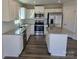 This spacious kitchen features granite countertops, an island, stainless steel appliances, and wood-look flooring at 609 Grandiflora Ave, Lancaster, SC 29720