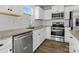 This kitchen has white cabinets, stainless steel appliances, granite countertops, and wood-look floors at 609 Grandiflora Ave, Lancaster, SC 29720