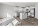 Bright kitchen with white cabinets, stainless steel appliances, a kitchen island, and modern flooring at 609 Grandiflora Ave, Lancaster, SC 29720