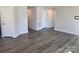 Open-concept living room with gray walls, white trim, wood-look floors, and multiple doorways at 609 Grandiflora Ave, Lancaster, SC 29720