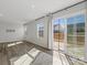 Bright living room with gray walls, wood-look floors, and sliding glass doors to the backyard at 609 Grandiflora Ave, Lancaster, SC 29720