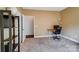 Home office featuring a neutral color scheme with a black bookshelf, modern desk, and bright natural light at 6618 Alexander Rd, Charlotte, NC 28270