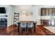 Dining area with hardwood floors, a modern light fixture, and a view into the kitchen at 6618 Alexander Rd, Charlotte, NC 28270