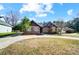 Charming brick home with a well-manicured lawn, a driveway, and mature landscaping at 6618 Alexander Rd, Charlotte, NC 28270
