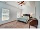 Spacious main bedroom featuring a tray ceiling, neutral color scheme, and two windows for natural light at 6618 Alexander Rd, Charlotte, NC 28270