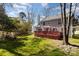 Large backyard with mature trees, a privacy fence and the home's rear deck at 7533 Lady Bank Dr, Charlotte, NC 28269