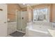 Bathroom featuring a tub and separate shower with tile surround and window at 7533 Lady Bank Dr, Charlotte, NC 28269