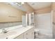Bright bathroom featuring double sinks, a large mirror and a combined shower and tub at 7533 Lady Bank Dr, Charlotte, NC 28269
