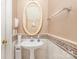 Charming half bathroom featuring pedestal sink and decorative mosaic tiling at 7533 Lady Bank Dr, Charlotte, NC 28269