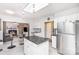 Bright kitchen with island, stainless steel refrigerator, and view to living room at 7533 Lady Bank Dr, Charlotte, NC 28269