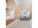 Bright living room featuring large windows, a staircase, and neutral carpeting at 7533 Lady Bank Dr, Charlotte, NC 28269
