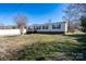 Single-story home with vinyl siding, black shutters, and a wooden deck in a yard at 7536 Beaver Rd, Kannapolis, NC 28081