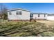 Exterior of home showing siding, brick foundation, small deck, and fenced yard at 7536 Beaver Rd, Kannapolis, NC 28081