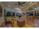Inviting covered back porch with outdoor seating, ceiling fans, and tranquil backyard views at 7704 Sharpthorne Pl, Charlotte, NC 28270