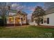 Spacious backyard with covered porch, patio area, and well-maintained lawn perfect for outdoor living at 7704 Sharpthorne Pl, Charlotte, NC 28270