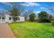 Well-maintained backyard features a large lawn, brick path, and privacy fencing at 7704 Sharpthorne Pl, Charlotte, NC 28270