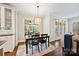 A charming dining area boasts hardwood floors, bright windows, and a stylish chandelier above the table at 7704 Sharpthorne Pl, Charlotte, NC 28270