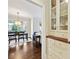 A dining area with hardwood floors, large bright windows, and a view into the main living room at 7704 Sharpthorne Pl, Charlotte, NC 28270