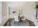 Elegant dining room featuring a round table, stylish chandelier, and bright natural light from the windows at 7704 Sharpthorne Pl, Charlotte, NC 28270