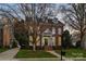 Charming red brick two-story home with symmetrical windows, a landscaped yard, and inviting front entrance at 7704 Sharpthorne Pl, Charlotte, NC 28270