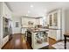 A well-lit kitchen features a butcher block island, white cabinets, and modern stainless steel appliances at 7704 Sharpthorne Pl, Charlotte, NC 28270