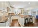 The bright kitchen has a butcher block island with seating, sleek countertops, and stainless steel appliances at 7704 Sharpthorne Pl, Charlotte, NC 28270