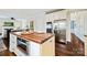 A lovely kitchen with stainless steel appliances, wood flooring, and a butcher block island at 7704 Sharpthorne Pl, Charlotte, NC 28270