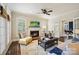 Inviting living room with a fireplace, comfortable seating, and lots of light streaming through the windows at 7704 Sharpthorne Pl, Charlotte, NC 28270