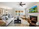 Bright and open living room featuring a fireplace, comfortable seating, and access to the outdoor patio area at 7704 Sharpthorne Pl, Charlotte, NC 28270