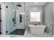 Elegant bathroom featuring marble-style tiles, a glass-enclosed shower, and a soaking tub at 805 Tirzah Rd, York, SC 29745