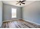 Bright bedroom with hardwood floors, neutral walls, and a large window at 805 Tirzah Rd, York, SC 29745