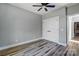 A bedroom features light gray walls, wood-look floors, ceiling fan and a white closet door at 805 Tirzah Rd, York, SC 29745