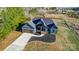 Aerial view of a charming blue house with a spacious yard, surrounded by lush trees at 805 Tirzah Rd, York, SC 29745